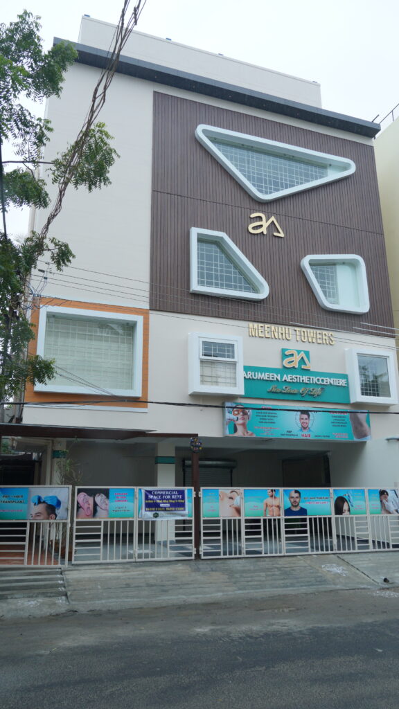 Entrance of Arumeen Aesthetic Centere Hair Treatment Clinic in Thillai Nagar, Trichy, offering hair transplant, PRP hair treatment, and hair loss solutions.
